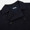 View 2 of product The Navy Short Albert Trench Coat by Turnbull & Asser UK features dark navy fabric, six black buttons, a notched collar, long sleeves with adjustable cuffs, and front zip pockets—displayed on a plain white background.