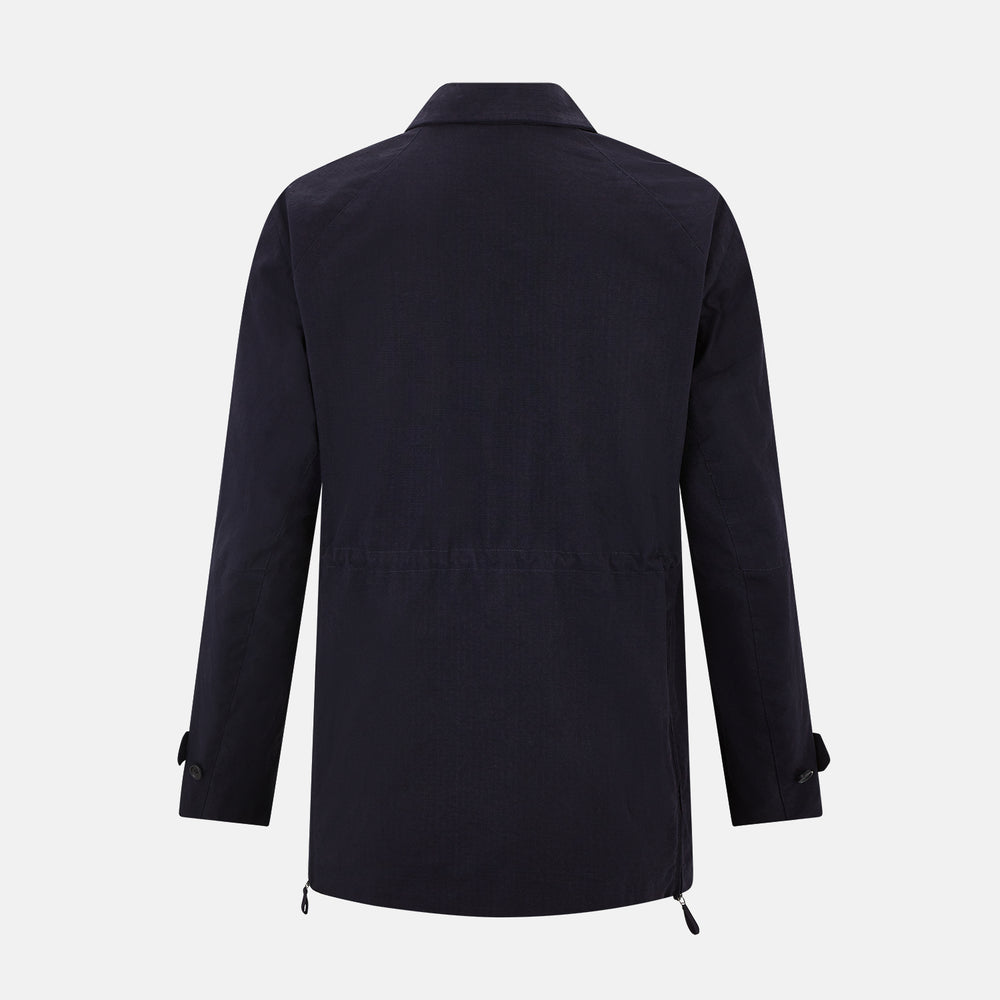 The Navy Short Albert Trench Coat by Turnbull & Asser UK features dark navy fabric, six black buttons, a notched collar, long sleeves with adjustable cuffs, and front zip pockets—displayed on a plain white background.