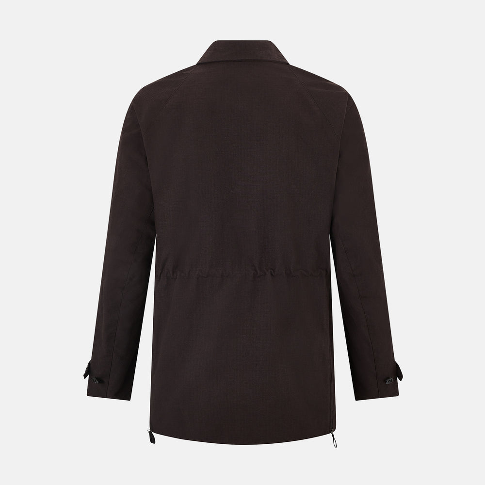 The Turnbull & Asser UK Dark Chocolate Short Albert Trench Coat features a double-breasted style, black buttons, notched collar, chest pocket, two side zip pockets, and adjustable cuff straps—shown on a plain white background.