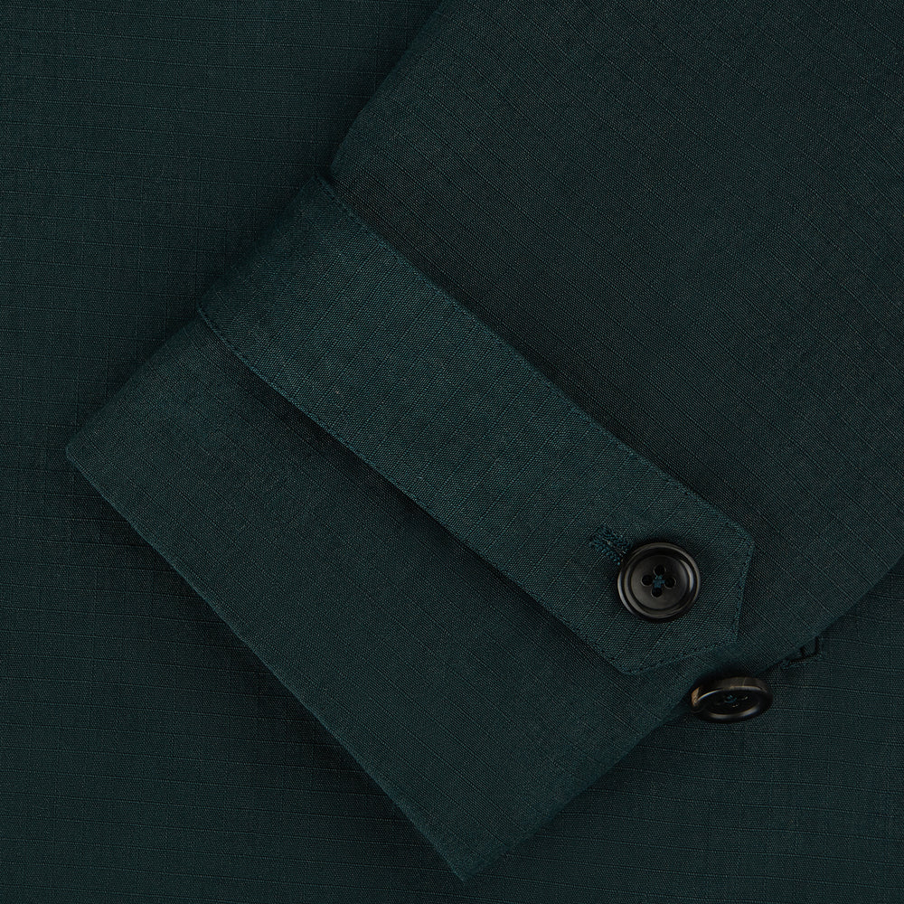 Turnbull & Asser UK's Forest Green Short Albert Trench Coat features a double-breasted design, black buttons, front chest pocket, two zippered side pockets, and strapped cuffs, shown against a plain white background.