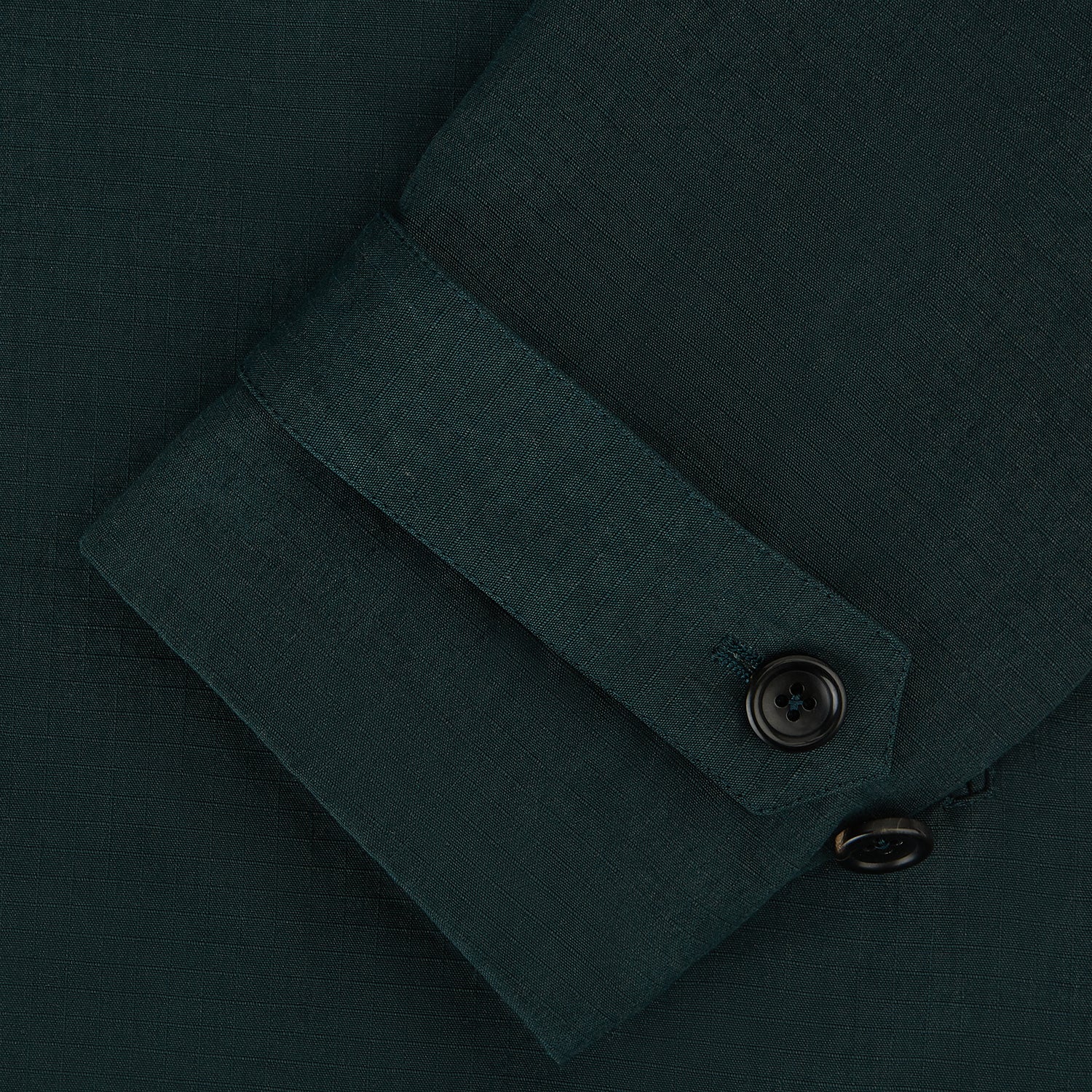 View 4 of product Turnbull & Asser UK's Forest Green Short Albert Trench Coat features a double-breasted design, black buttons, front chest pocket, two zippered side pockets, and strapped cuffs, shown against a plain white background.