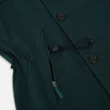 View 5 of product Turnbull & Asser UK's Forest Green Short Albert Trench Coat features a double-breasted design, black buttons, front chest pocket, two zippered side pockets, and strapped cuffs, shown against a plain white background.