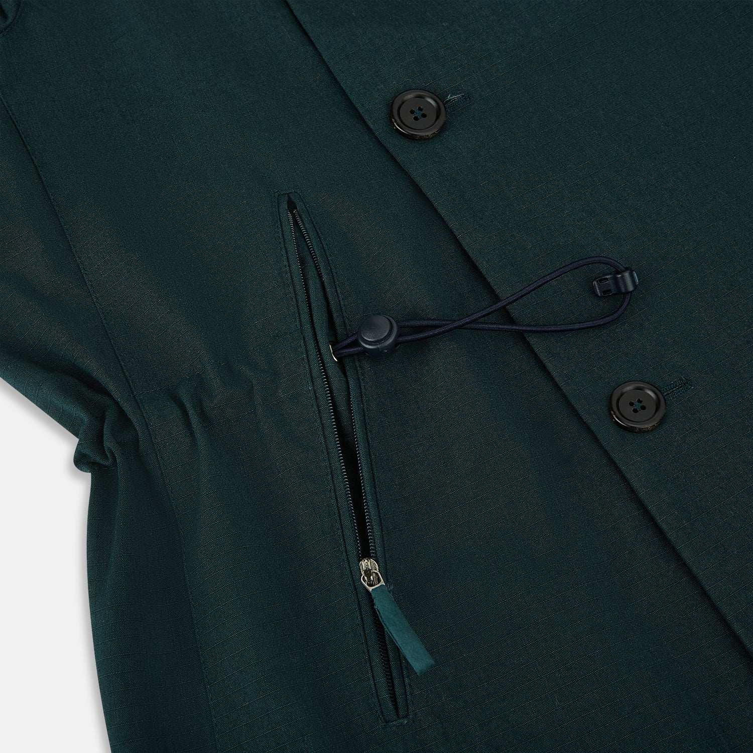 View 5 of product Turnbull & Asser UK's Forest Green Short Albert Trench Coat features a double-breasted design, black buttons, front chest pocket, two zippered side pockets, and strapped cuffs, shown against a plain white background.