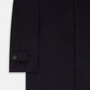 View 3 of product The Turnbull & Asser Dark Navy Cashmere Storm System Smith Coat, featuring a classic collar, buttoned front, side pockets, and buttoned cuffs, is shown laid flat on a white background.