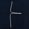 View 3 of product The Turnbull & Asser Navy Piped Cotton Pyjama Set features a navy blue long-sleeve top with white piping, front buttons, a chest pocket, and matching drawstring pants, all displayed on a white background.