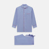 View 1 of product The Blue Piped End-on-End Cotton Pyjama Set by Turnbull & Asser features light blue long sleeves, red piping, front buttons, chest pocket, and matching drawstring pants—luxurious sleepwear laid flat on a white background.