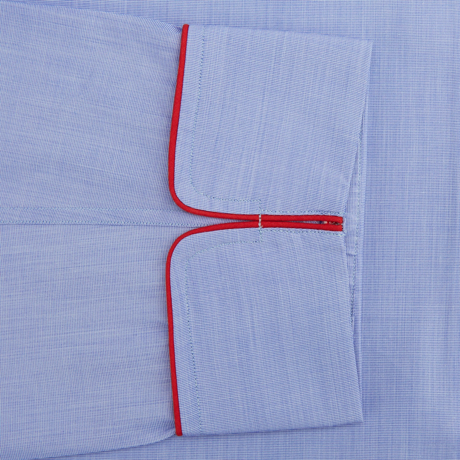 View 3 of product The Blue Piped End-on-End Cotton Pyjama Set by Turnbull & Asser features light blue long sleeves, red piping, front buttons, chest pocket, and matching drawstring pants—luxurious sleepwear laid flat on a white background.