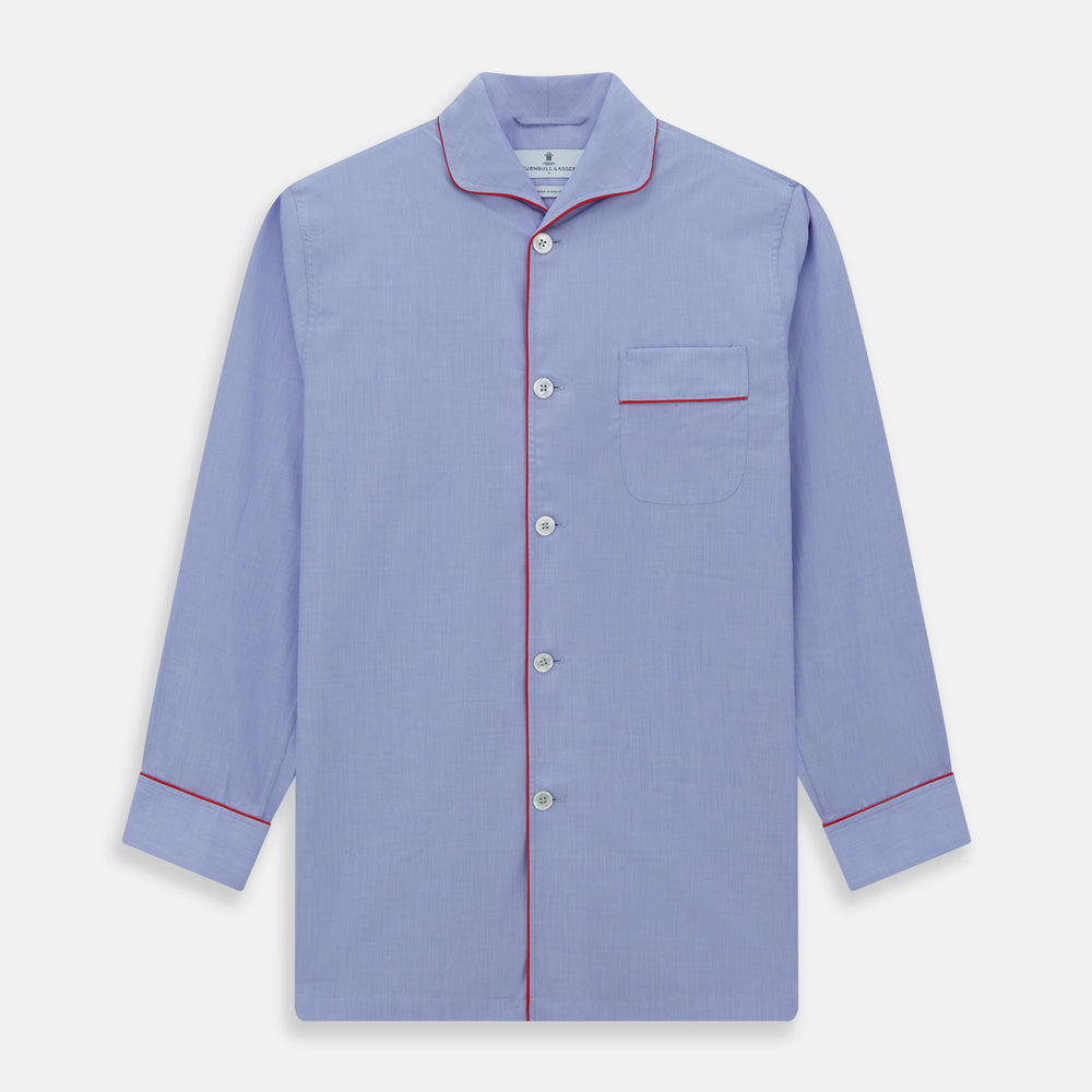 The Blue Piped End-on-End Cotton Pyjama Set by Turnbull & Asser features light blue long sleeves, red piping, front buttons, chest pocket, and matching drawstring pants—luxurious sleepwear laid flat on a white background.