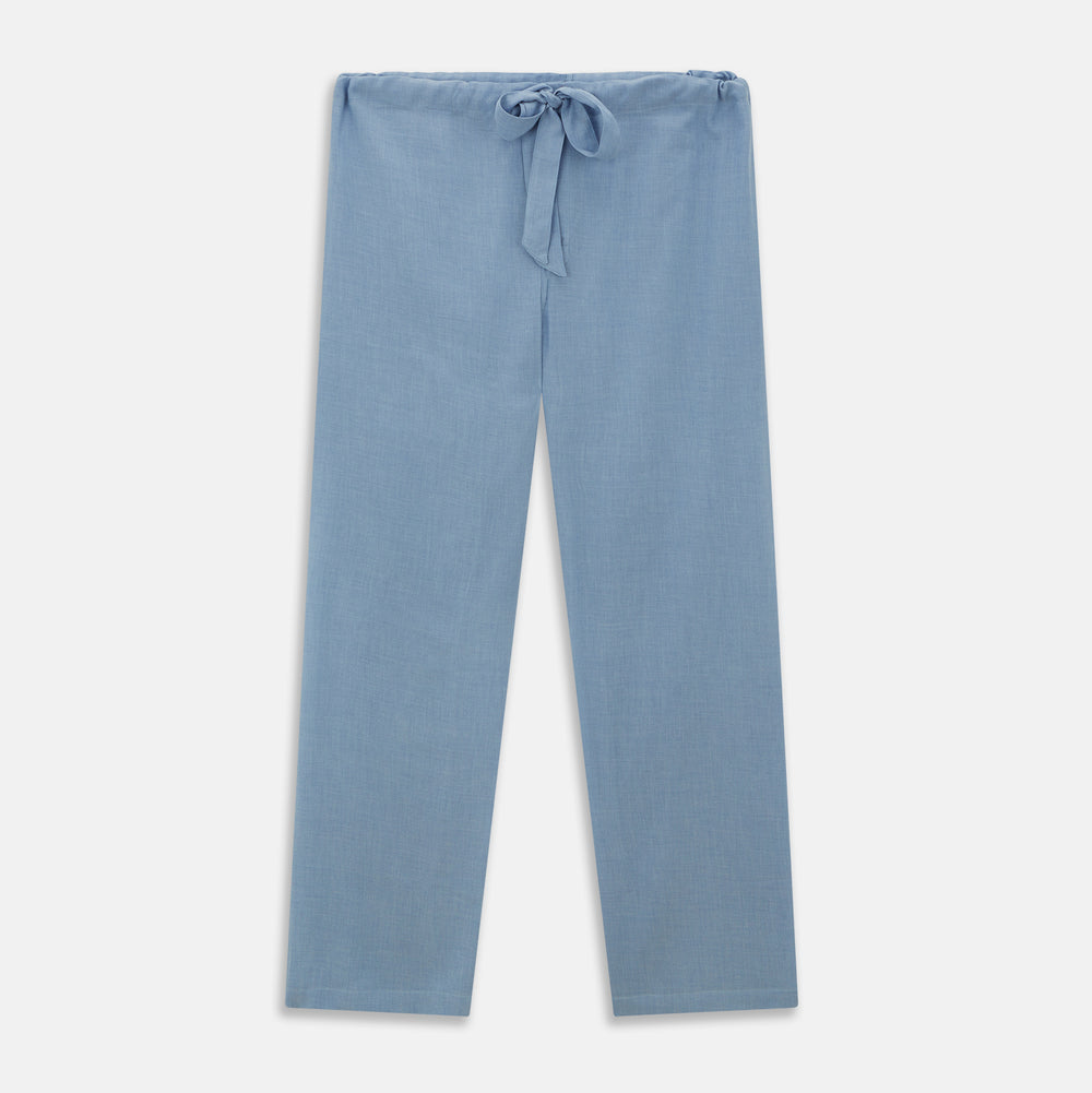 The Blue Piped Cotton-Cashmere Pyjama Set by Turnbull & Asser features a light blue long-sleeved, button-up top with a chest pocket and dark piping, plus matching side-tie pants—luxurious comfort displayed on a white background.