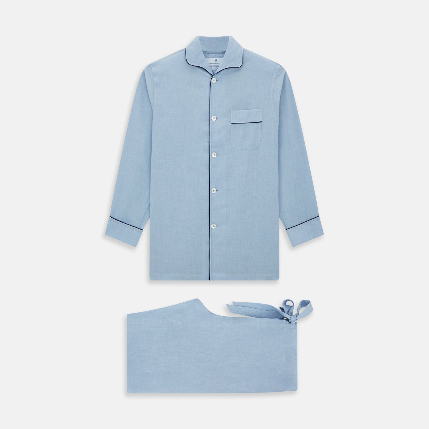 View 1 of product The Blue Piped Cotton-Cashmere Pyjama Set by Turnbull & Asser features a light blue long-sleeved, button-up top with a chest pocket and dark piping, plus matching side-tie pants—luxurious comfort displayed on a white background.