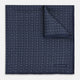 A Floral Navy Pocket Square in Silk by Turnbull & Asser UK, featuring a repeating geometric pattern with the brand’s name printed in white in the corner—perfect for adding a touch of sophistication to formal tailoring. The top right edge is folded over to reveal the reverse side.