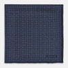 View 3 of product A Floral Navy Pocket Square in Silk by Turnbull & Asser UK, featuring a repeating geometric pattern with the brand’s name printed in white in the corner—perfect for adding a touch of sophistication to formal tailoring. The top right edge is folded over to reveal the reverse side.