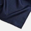 View 2 of product The Checked Blue On Navy Pocket Square in Silk by Turnbull & Asser UK is crafted from dark blue silk and features a subtle geometric design with a lighter blue grid pattern, finished with a discreet Turnbull & Asser logo in the corner.