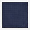 View 3 of product The Checked Blue On Navy Pocket Square in Silk by Turnbull & Asser UK is crafted from dark blue silk and features a subtle geometric design with a lighter blue grid pattern, finished with a discreet Turnbull & Asser logo in the corner.