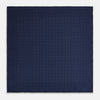 View 4 of product The Checked Blue On Navy Pocket Square in Silk by Turnbull & Asser UK is crafted from dark blue silk and features a subtle geometric design with a lighter blue grid pattern, finished with a discreet Turnbull & Asser logo in the corner.