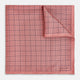 Introducing the Checked Pink Pocket Square in Silk from Turnbull & Asser UK, crafted with a geometric grid pattern of black lines and micro dots on soft pink silk. The design features a neatly folded corner and "Turnbull & Asser" subtly printed in the bottom right.