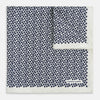 View 1 of product A refined double-sided design, the Floral White Pocket Square in Silk by Turnbull & Asser UK features a small blue floral pattern on white silk, neatly folded to display both its intricate front and bordered corner—adding subtle elegance to any ensemble.
