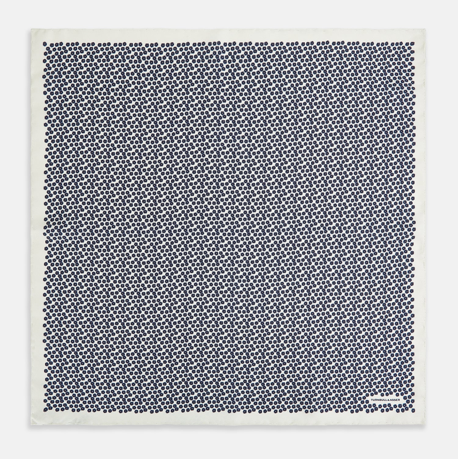 View 4 of product A refined double-sided design, the Floral White Pocket Square in Silk by Turnbull & Asser UK features a small blue floral pattern on white silk, neatly folded to display both its intricate front and bordered corner—adding subtle elegance to any ensemble.