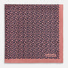 View 3 of product A folded Floral Pink Pocket Square in Silk by Turnbull & Asser UK, adorned with a pattern of small navy blue circles and the brand name printed in one corner, features a refined double-sided design for added versatility.