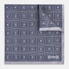 View 1 of product A folded, square Turnbull & Asser UK Geometric Grey Pocket Square in Silk featuring a geometric black and white concentric squares pattern accented with subtle navy lines, finished with a small Turnbull & Asser label in one corner.