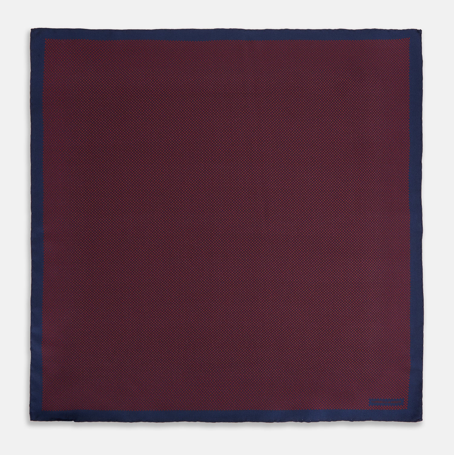 View 4 of product A Polka dot Burgundy Pocket Square in Silk by Turnbull & Asser UK, featuring a subtle micro motif and a solid navy border, partially folded at the top right corner.