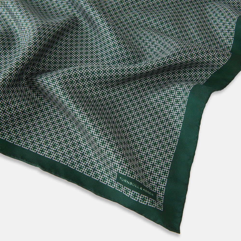 Turnbull & Asser UK Geometric Green Forest Green Pocket Square in Silk featuring a white geometric motif and a solid green border.