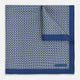 A blue pocket square from Turnbull & Asser UK, featuring a geometric white square pattern and a solid blue border. One corner is folded to highlight the striking design on both sides, with the brand name displayed on the bottom right. Product name: POCKET SQUARE SQUARE PATTERNED BANANA.