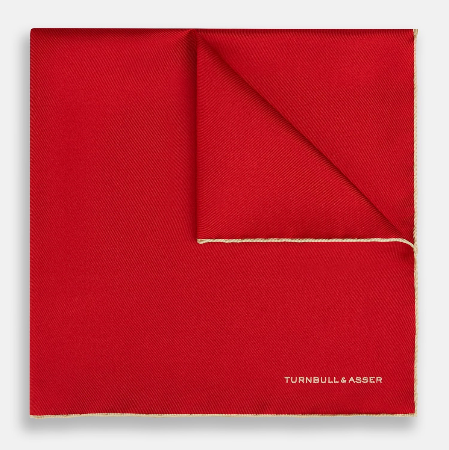 View 1 of product The Turnbull & Asser RED AND GOLD PIPED SILK POCKET SQUARE is a vibrant red silk accessory with gold edging and the brand’s logo in white on the bottom right—ideal for elevating formal looks.