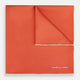 The Orange and White Piped Silk Pocket Square by Turnbull & Asser features a solid orange design with white piping and the brand’s logo in the bottom right corner, making it an elegant addition to any formal outfit.