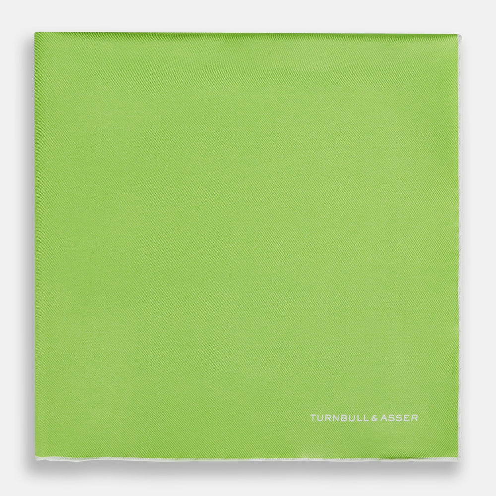 The Lime Green and Ecru Piped Silk Pocket Square by Turnbull & Asser adds a refined touch to any formal look.