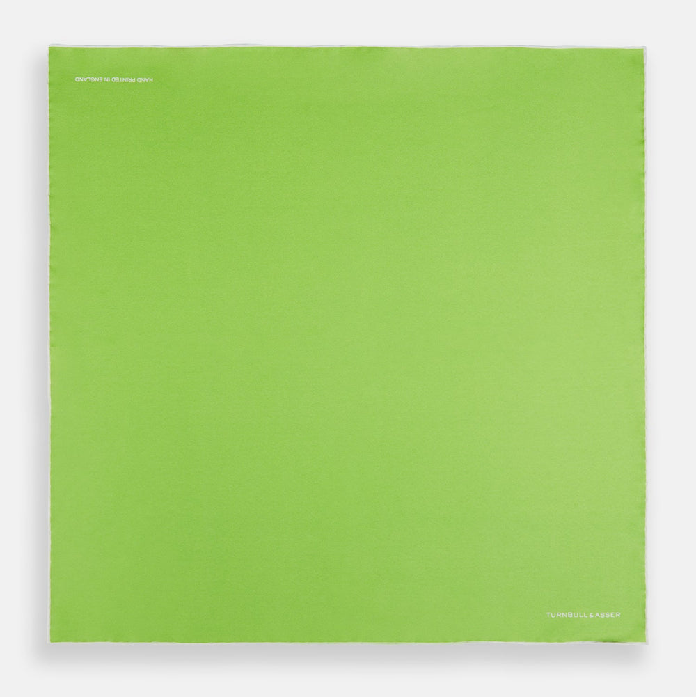 The Lime Green and Ecru Piped Silk Pocket Square by Turnbull & Asser adds a refined touch to any formal look.