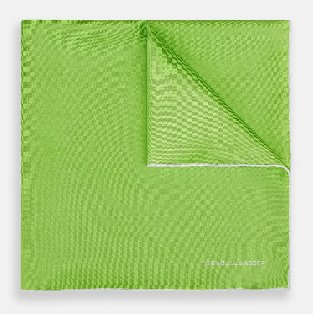 The Lime Green and Ecru Piped Silk Pocket Square by Turnbull & Asser adds a refined touch to any formal look.