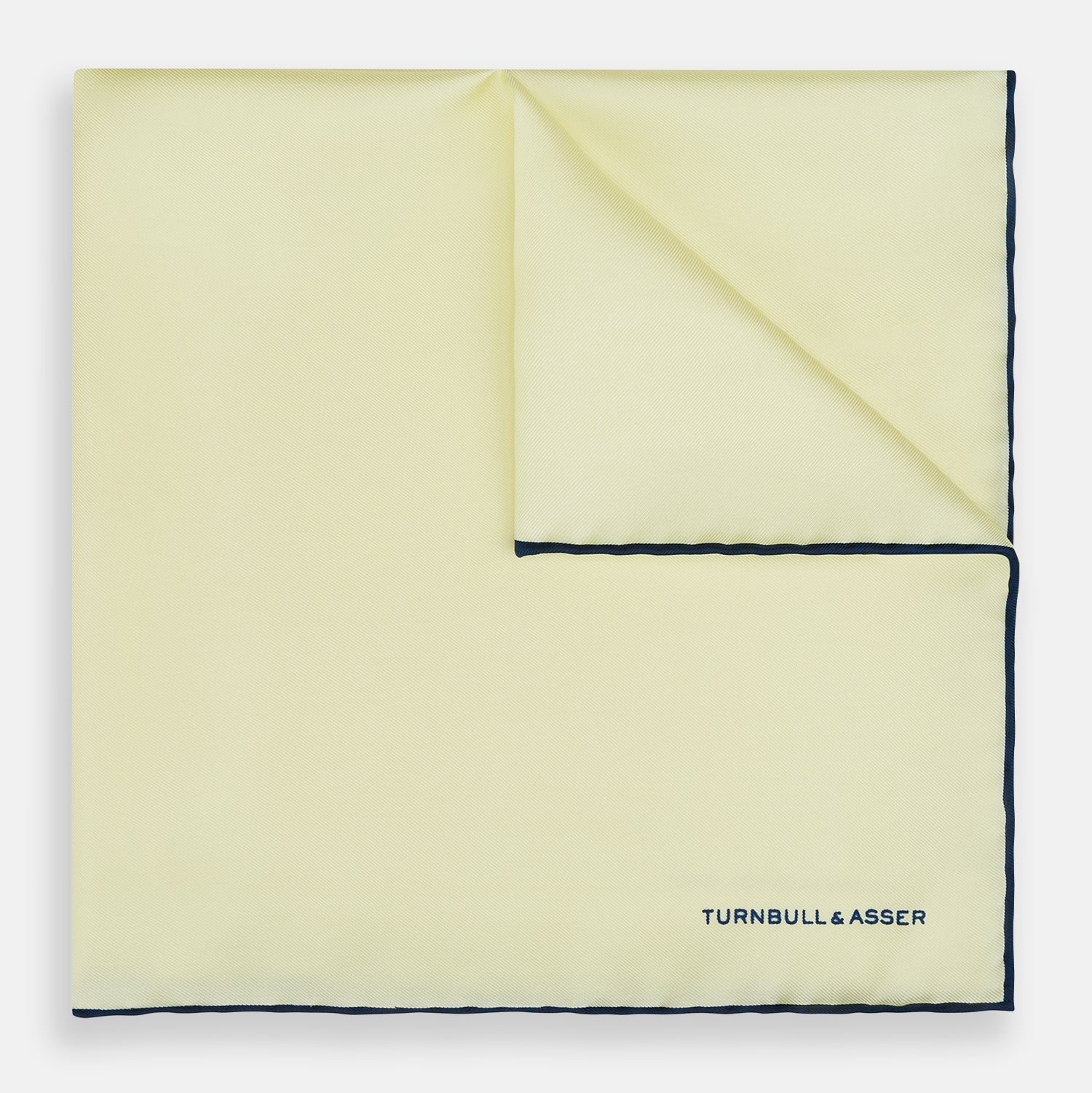 View 1 of product The Turnbull & Asser GOLD AND NAVY BLUE PIPED SILK POCKET SQUARE features navy piping and an embroidered logo—a refined accessory to elevate any formal look.