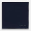 View 3 of product The Midnight Blue Piped Silk Pocket Square from Turnbull & Asser features crisp white trim and subtle branding, making it the ideal accessory to elevate your formal look.