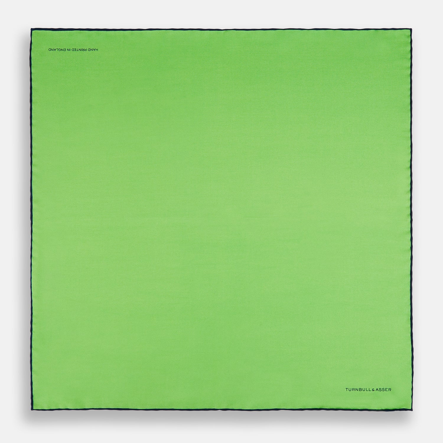 View 4 of product A neatly folded Turnbull & Asser LIGHT GREEN AND BLACK PIPED SILK POCKET SQUARE—ideal for elevating formal attire.