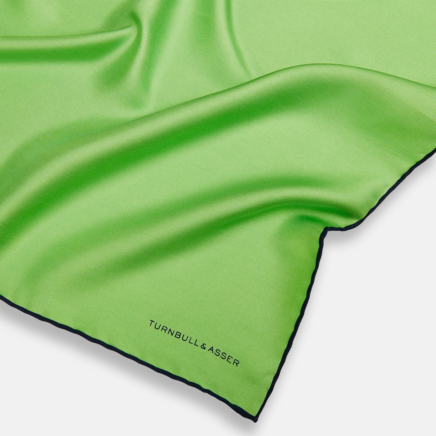 View 2 of product A neatly folded Turnbull & Asser LIGHT GREEN AND BLACK PIPED SILK POCKET SQUARE—ideal for elevating formal attire.