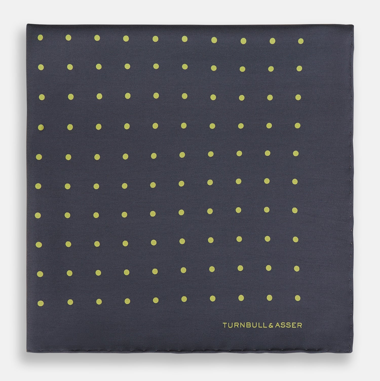 View 3 of product A grey and lime spot silk pocket square by Turnbull & Asser, featuring evenly spaced dots and the brand's logo in one corner—perfect for adding a stylish touch to formal attire.