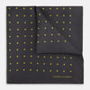 View 1 of product A grey and lime spot silk pocket square by Turnbull & Asser, featuring evenly spaced dots and the brand's logo in one corner—perfect for adding a stylish touch to formal attire.