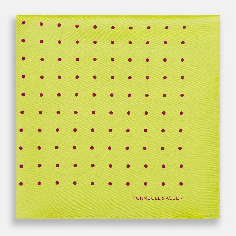 The Turnbull & Asser Chartreuse and Mauve Spot Silk Pocket Square features evenly spaced mauve dots and a branded corner—an ideal accessory to enhance your formal look.