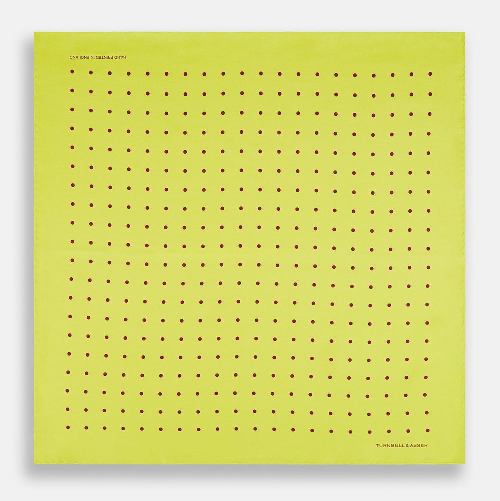 The Turnbull & Asser Chartreuse and Mauve Spot Silk Pocket Square features evenly spaced mauve dots and a branded corner—an ideal accessory to enhance your formal look.