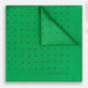 The Green and Navy Spot Silk Pocket Square by Turnbull & Asser features evenly spaced navy spots on green silk, with the brand name printed in the lower right corner and one corner folded over. Ideal for formal wear.