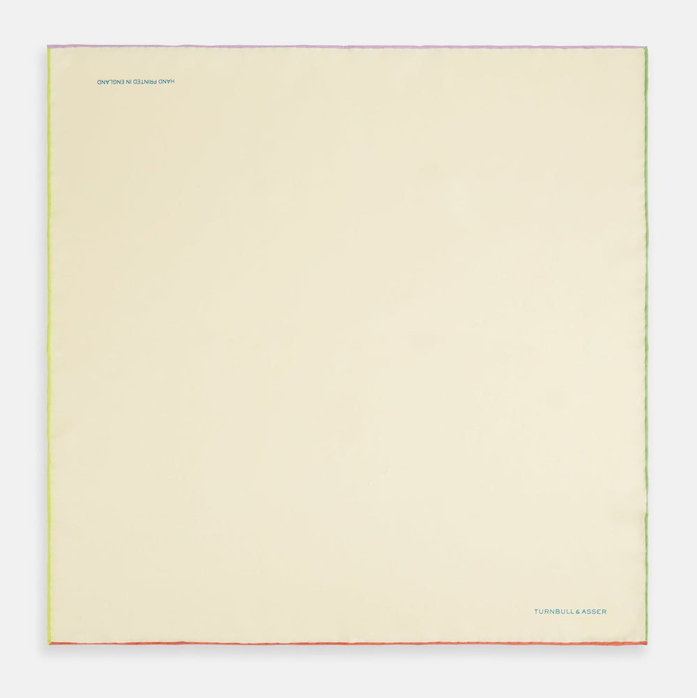 The Turnbull & Asser Ecru and Multicoloured Piped Silk Pocket Square features green and orange piping, blue "TURNBULL & ASSER" embroidery in the lower right, and a folded corner—a refined accessory for formal wear.