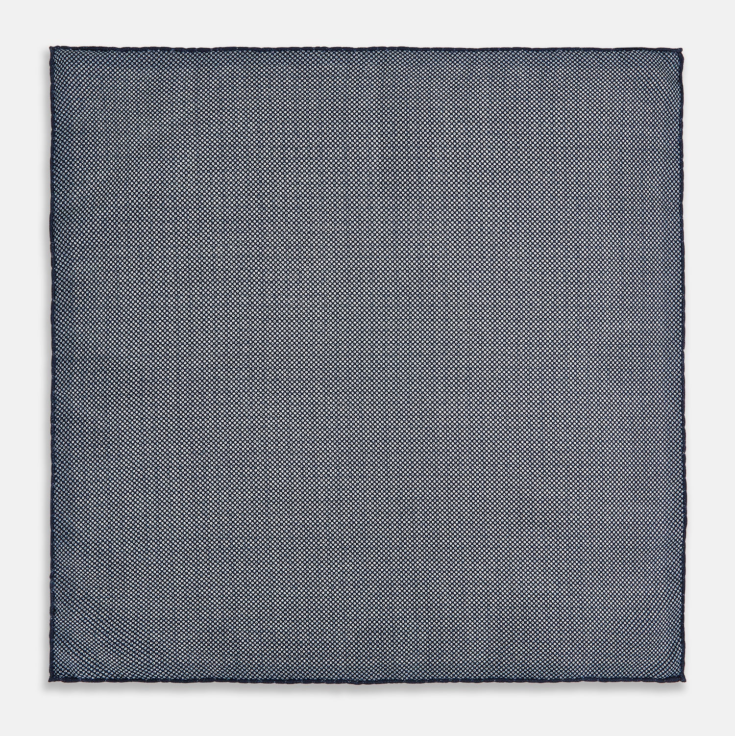 View 5 of product The Rosette Navy Pocket Square in Silk by Turnbull & Asser UK is a square, navy blue accessory featuring a small geometric pattern. Shown laid flat with one corner folded, it reveals a contrasting, finer motif on the reverse side. This elegant double-sided design offers versatile styling options for any occasion.