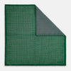 View 2 of product The Rosette Green Pocket Square in Silk by Turnbull & Asser UK features a small geometric medallion pattern and is shown folded to display a contrasting fine black-and-white design on the reverse side.