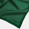 View 4 of product The Rosette Green Pocket Square in Silk by Turnbull & Asser UK features a small geometric medallion pattern and is shown folded to display a contrasting fine black-and-white design on the reverse side.