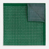 View 1 of product The Rosette Green Pocket Square in Silk by Turnbull & Asser UK features a small geometric medallion pattern and is shown folded to display a contrasting fine black-and-white design on the reverse side.