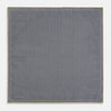 View 6 of product The Rosette Yellow Pocket Square in Silk by Turnbull & Asser UK features a square design with a yellow border, adorned with a grid of small black and white circles. One corner is neatly folded to reveal a reverse side in a refined black and white micro-checkered pattern, while subtle geometric medallions lend an added touch of elegance to the overall look.