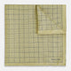 A yellow silk pocket square featuring a small black grid pattern of dotted squares, neatly folded at one corner. "Turnbull & Asser UK" is printed in the bottom right corner.