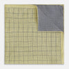 View 3 of product A yellow silk pocket square featuring a small black grid pattern of dotted squares, neatly folded at one corner. "Turnbull & Asser UK" is printed in the bottom right corner.
