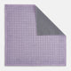 The Checked Lilac Pocket Square in Silk by Turnbull & Asser UK features a grid pattern in purple with a solid border, neatly folded to display its double-sided design and contrasting black and white dotted squares on the reverse side.